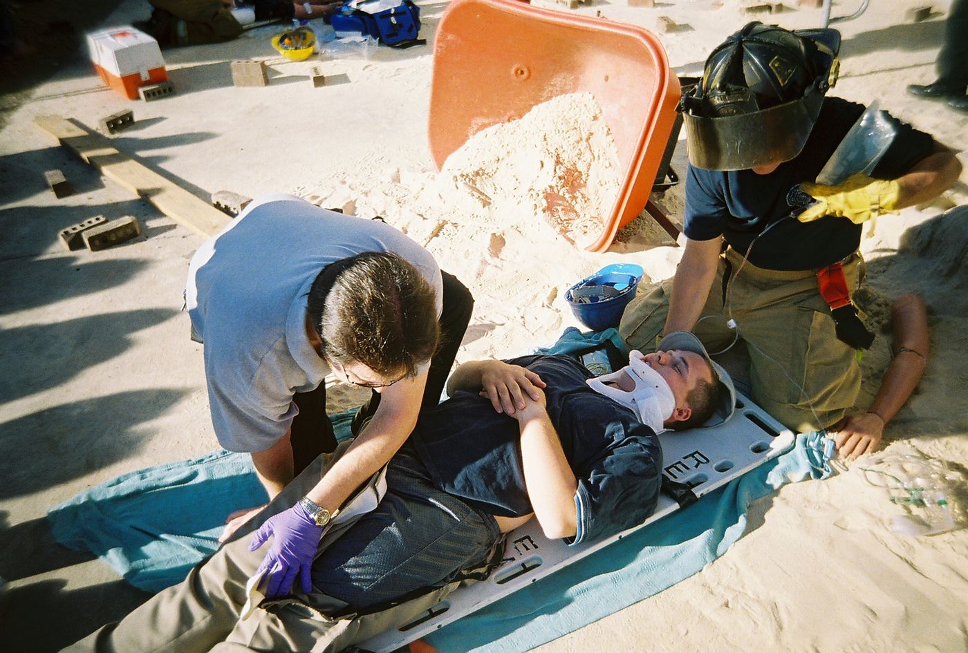 A team working a patient on a backboard in the sand in Sumter, 2006
