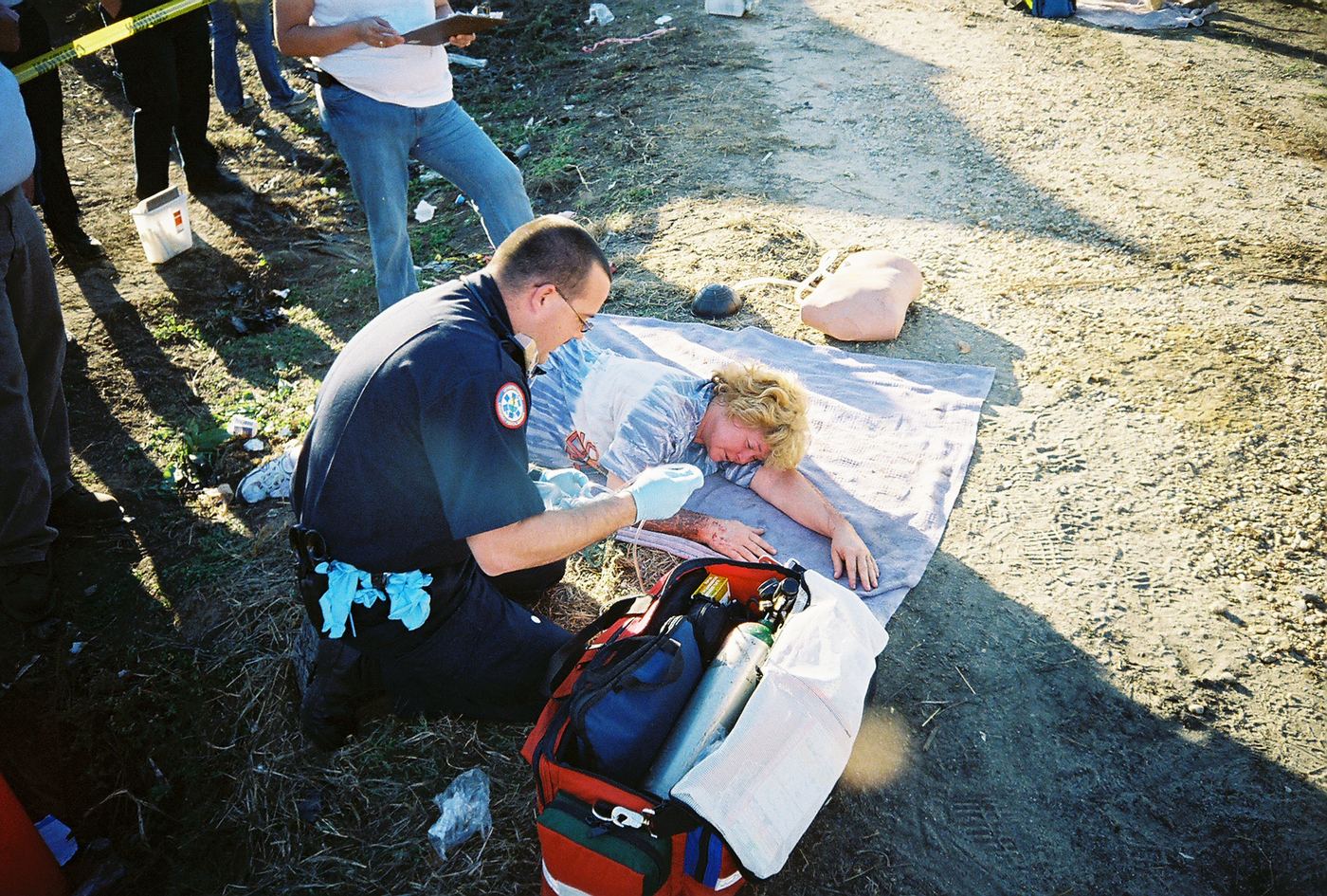 A medic working a patient on a blanket in Dunn, 2007