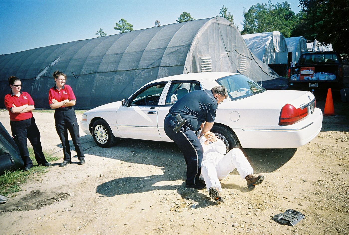 A medic helping a patient beside a white car in Dunn, 2007