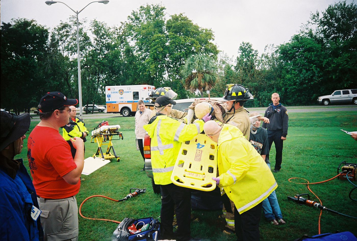 A crew packaging a patient on a backboard in a grassy field in Charleston, 2008